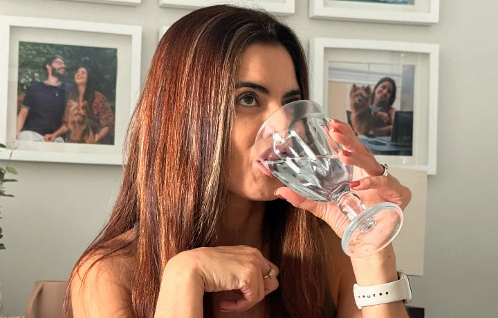 Mulher bebendo água com AERA40+ Vita